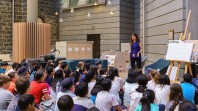 children's host presenting to seated children