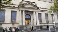 architects' mock-up of library entrance on city street with portico, steps and people queuing