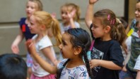 children dancing and clapping hands