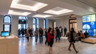 people walking through library foyer