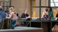 women at desks in public space