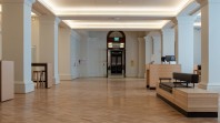 empty public hall with pillars and recessed lighting
