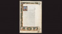 page from medieval manuscript against black background bordered with cherubs