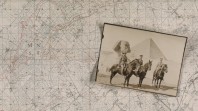 Three uniformed men pose on horses before the Sphinx and an Egyptian pyramid