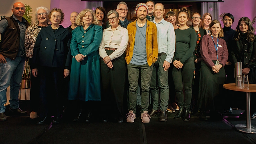 group shot of library fellows standing on a stage