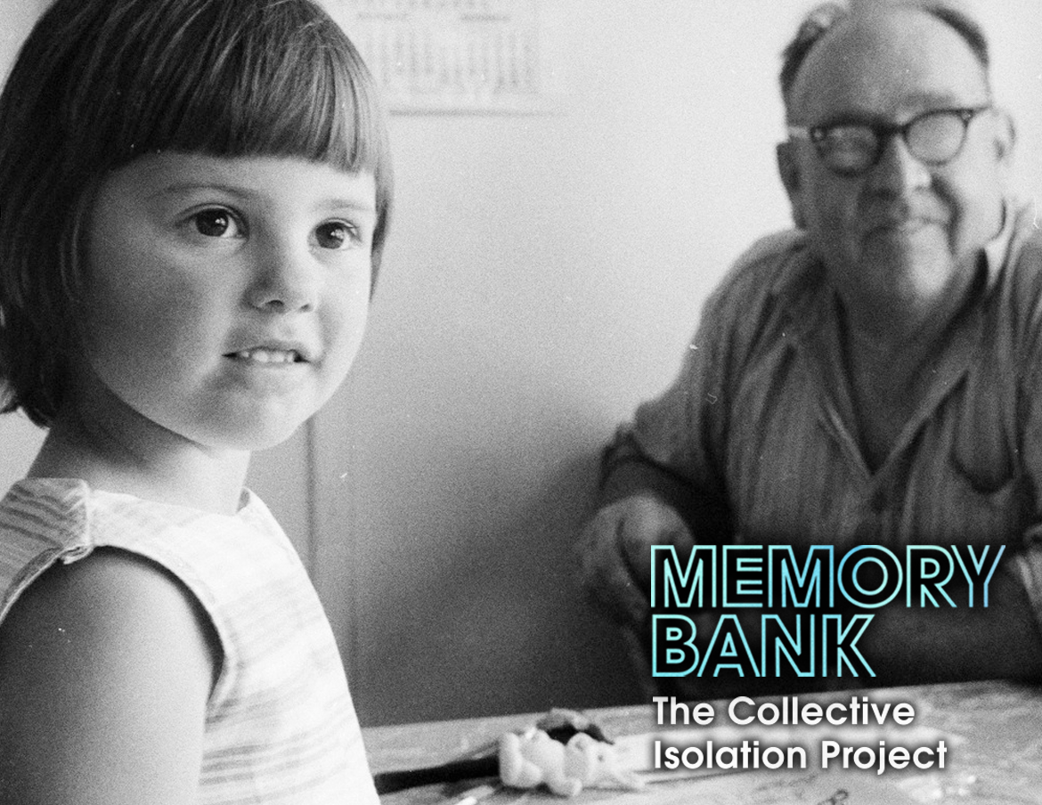 A grandfather sits at a table with his preschool-aged granddaughter