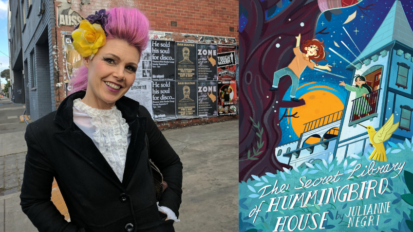 Woman with pink hair smiling next to cover of book