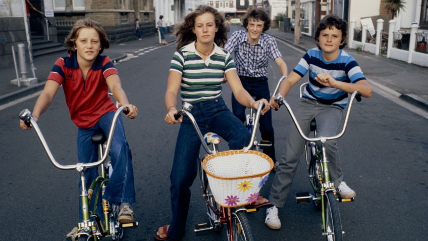 4 teens in 70s clothing on dragster bikes