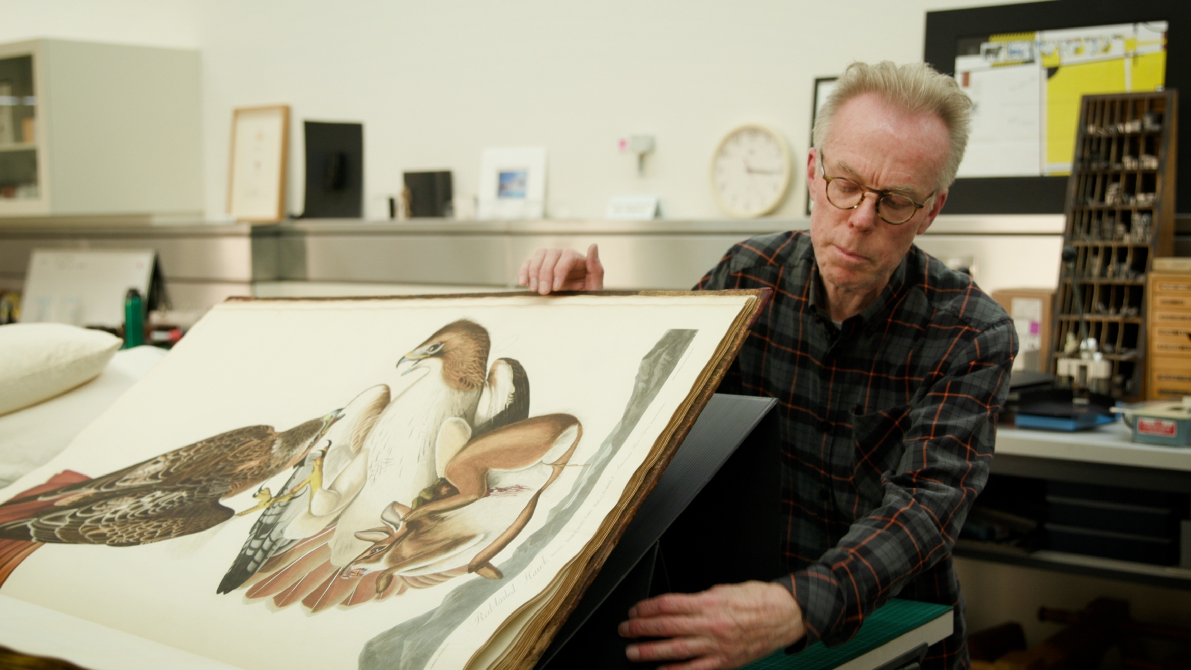 A man moving through the pages of a large book