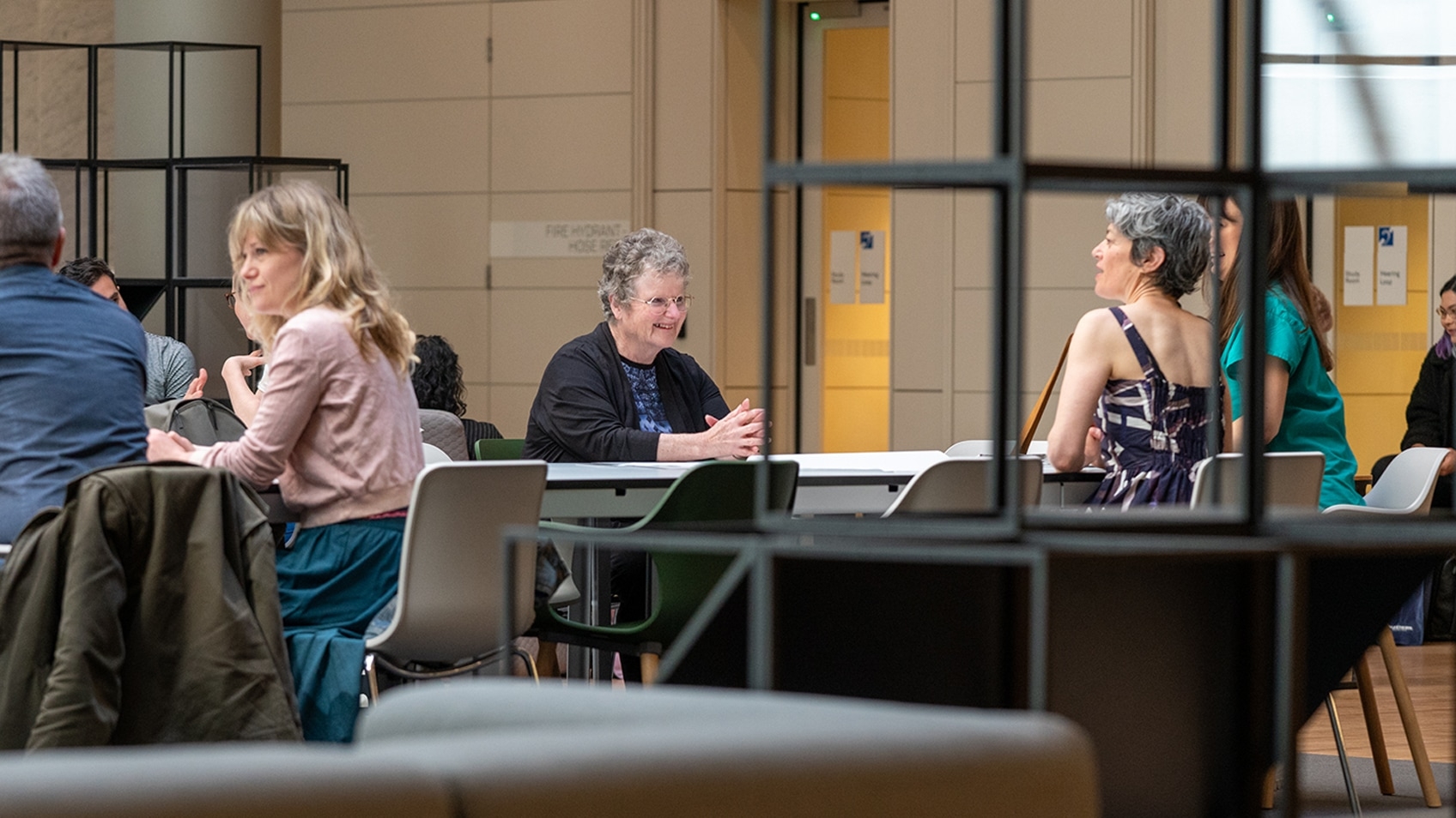 women at desks in public space