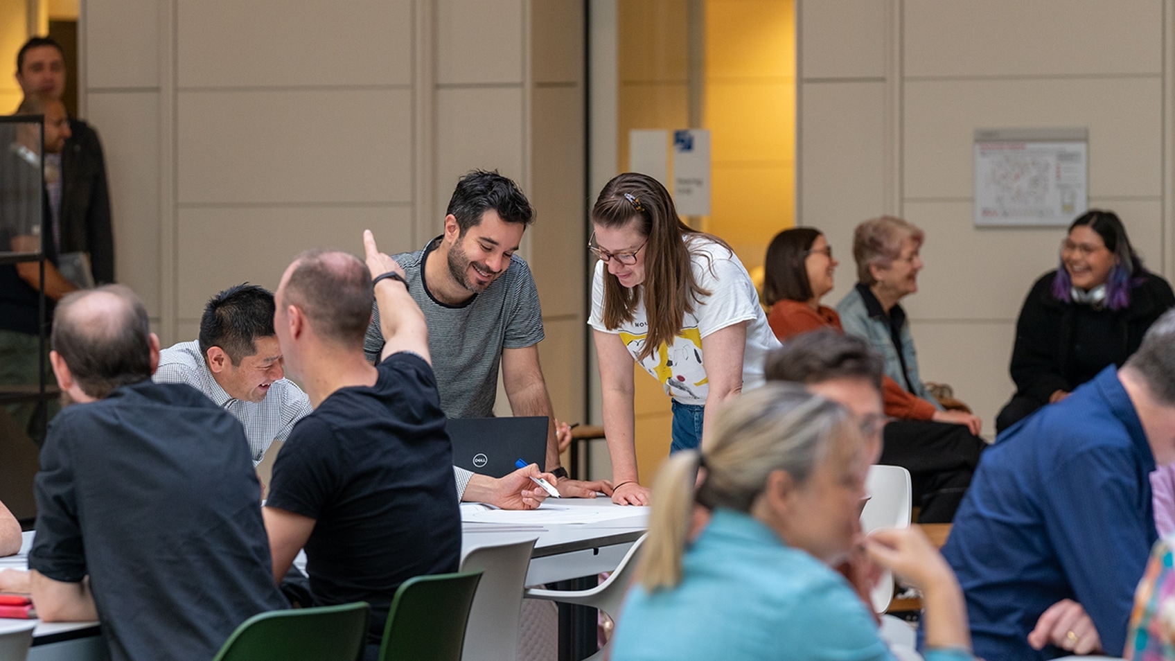 people working at two tables