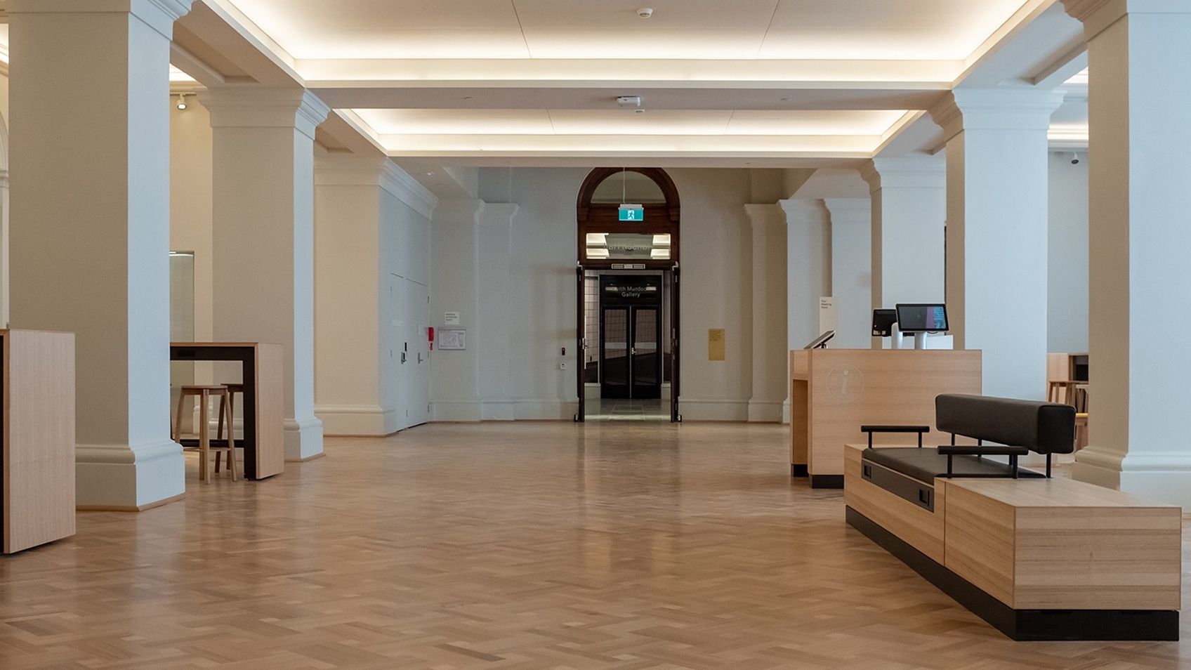 empty public hall with pillars and recessed lighting