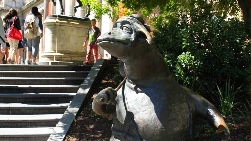 Colour photo of The Bunyip of Berkeley's Creek, Dromkeen sculpture, beside the front steps of State Library Victoria