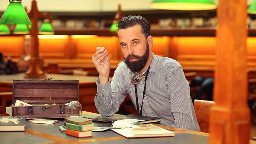 Photo of Nicholas Jones seated in the La Trobe Reading Room