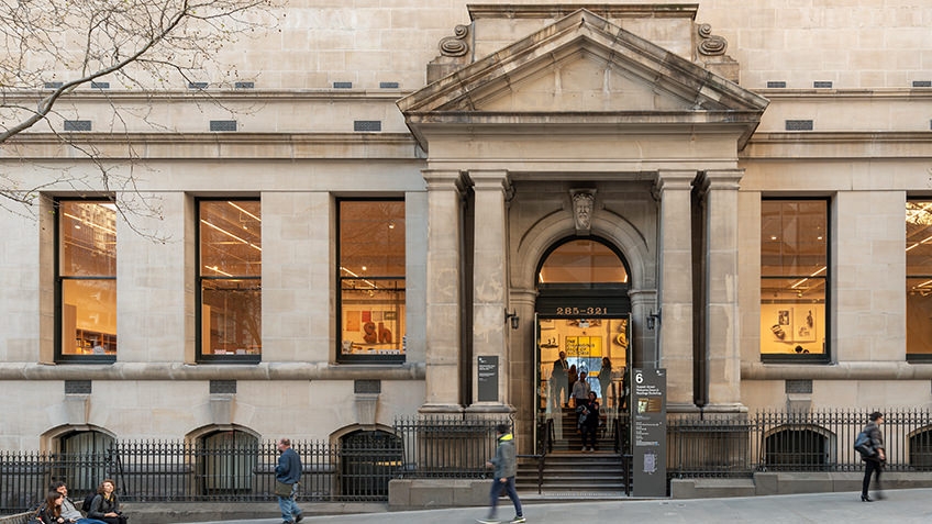 Russell Street library entrance with porticoed entry and illuminated windows