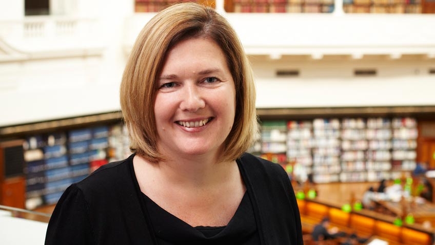 colour portrait of Sue Roberts, State Library Victoria CEO and State Librarian, 2012–15, with La Trobe Reading Room backdrop, by Andrew Lloyd 2012