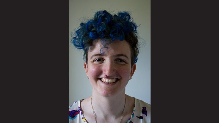 close up portrait of young female author with blue hair