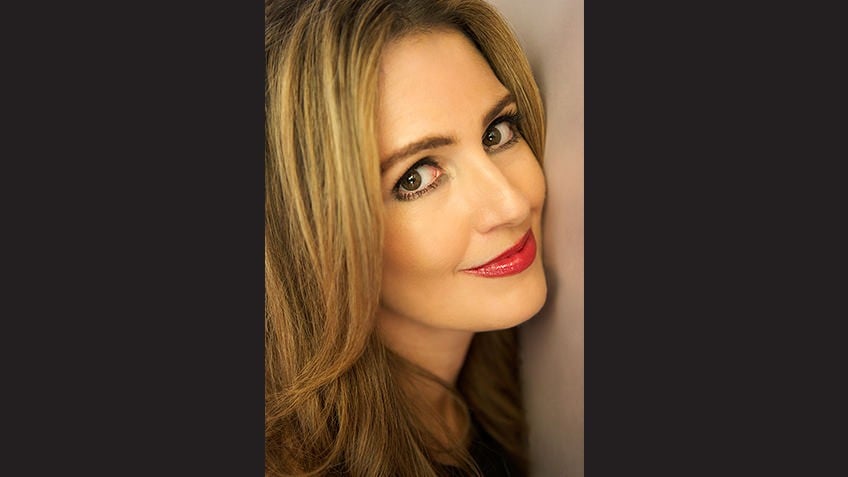 Cropped head shot against black background of blonde Young Adult author Jennifer Niven