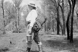 Black and white photo of a women walking in the Australian bushland