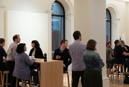 people standing and seated in meeting space