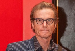 man with spectacles against red background