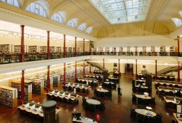 heritage reading room with mezzanine balconies, glass roof, shelves of books and study tables