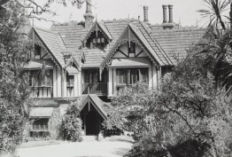 Black and white exterior photo by John T Collins of Tay Creggan in Hawthorn, a double-storey residence with imitation half-timbering, decorative timber barge-boards, steep gables and a tiled roof