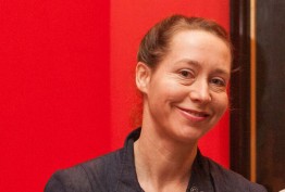 smiling woman against red background