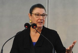 Susan Scollay speaking behind a lectern