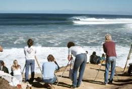 photographers on beach photographing waves and surfers