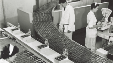 Women sort Freddo Frog chocolates on an assembly line