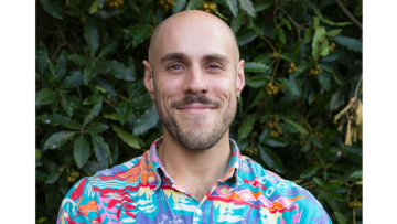 Author Dan Giovannoni wearing a colourful summer shirt.