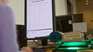 A patron using the computer searching through newspapers