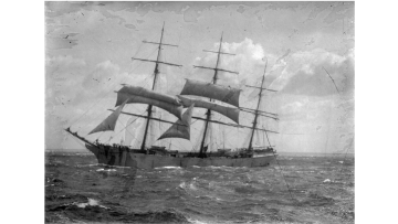 Black and white image of a ship at sea from the Allan C Green collection of glass negatives. 