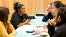 A group of students from around the world discuss a technical problem at the Future Founders Festival