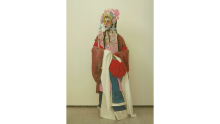 Hand coloured photo of a Cantonese Opera Male Dan performer as Hau Mulan in 1927, Hong Kong. In the exhibition artist Scotty So playfully challenges the truthfulness of photography and archives, blending beauty, history and illusion to explore identity, queerness, and the power of belief. Source State Library Victoria 