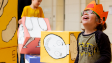 Happy children playing with boxes 