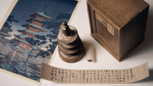 Hyakumantō Darani with wooden pagoda, storage box and facsimile text alongside a colour woodblock print of Horyuji Temple in Nara, Japan, where this particular darani was stored. 