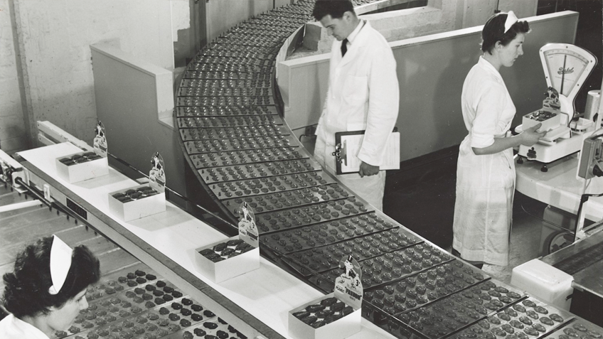 Women sort Freddo Frog chocolates on an assembly line