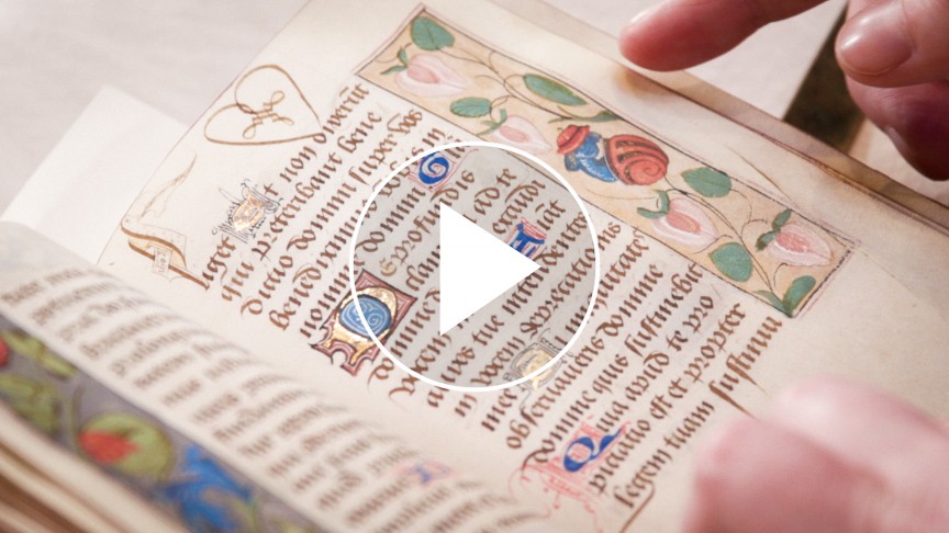 An open book with a play button on top