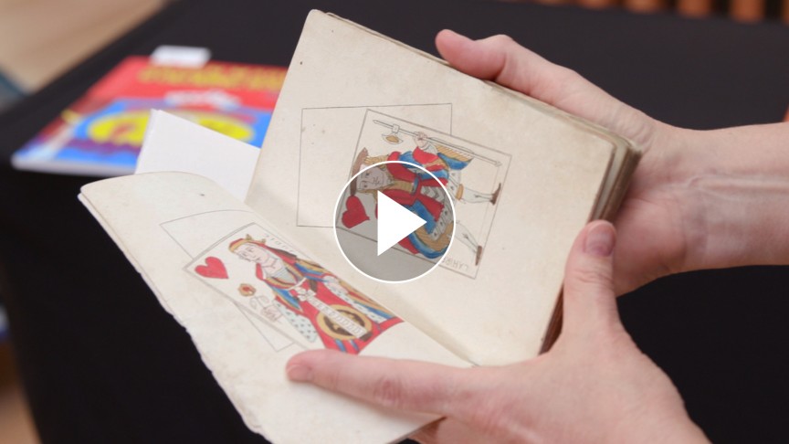 Open pages of a book with a play button on top