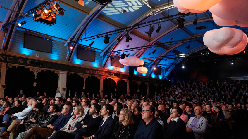 Crowd of people watching a presentation