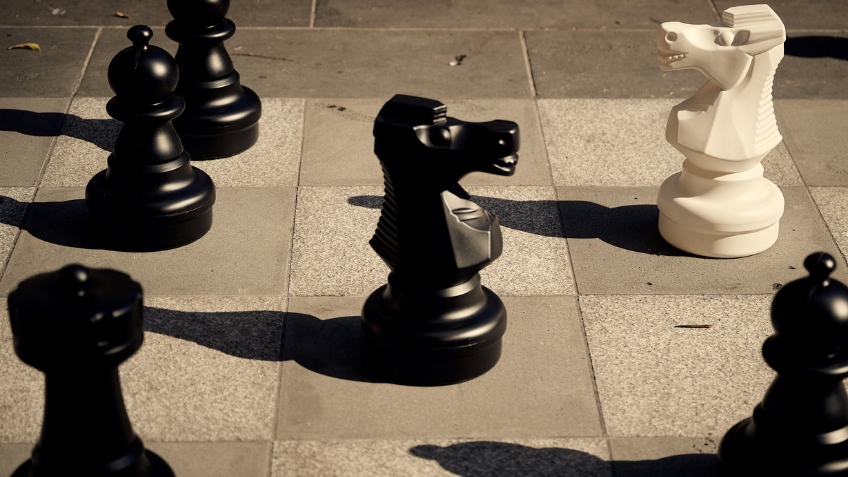 Black and white chess pieces on the Library's new permanent stone chessboard.