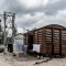 A burnt out train carriage with grey skies behind it
